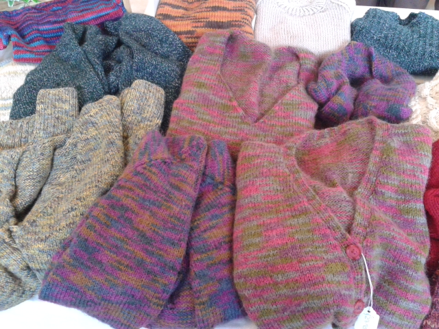 Hand Knitted clothes and sewing materials.